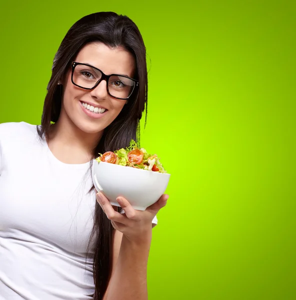 Chica joven mostrando un tazón de ensalada —  Fotos de Stock