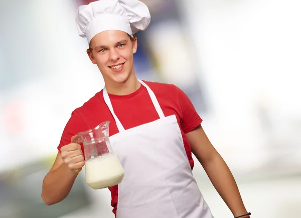 male chef holding jar of milk