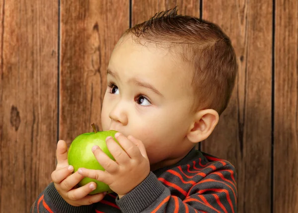 Porträtt av pojke som äter grönt äpple — Stockfoto