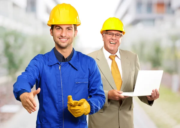 Architect Gesturing In Front Of Engineer Holding Clock — Stock Photo, Image