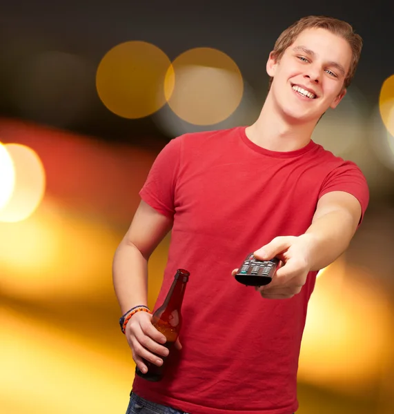 Portrait of a young man with remote control — Stock Photo, Image