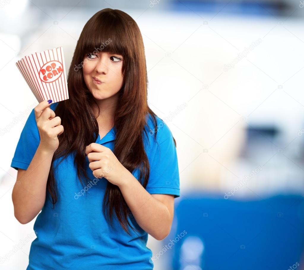 Girl Holding Empty Popcorn Packet — Stock Photo © Aaron_Amat 18816213