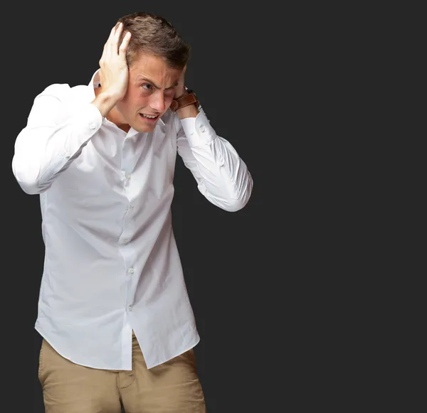 Portrait Of Young Man Covering His Ears With Hand — Stock Photo, Image