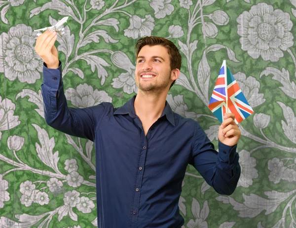 Man met vlag en miniatuur van vliegtuig — Stockfoto