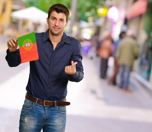 Young Man Holding Portugal Flag Gesturing