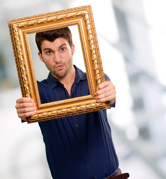 Young Man Holding Picture Frame — Stock Photo, Image