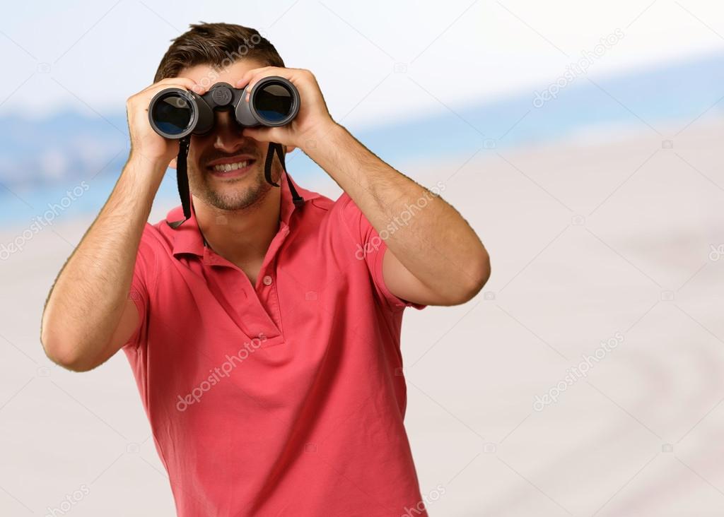 Young Man Holding Binoculars