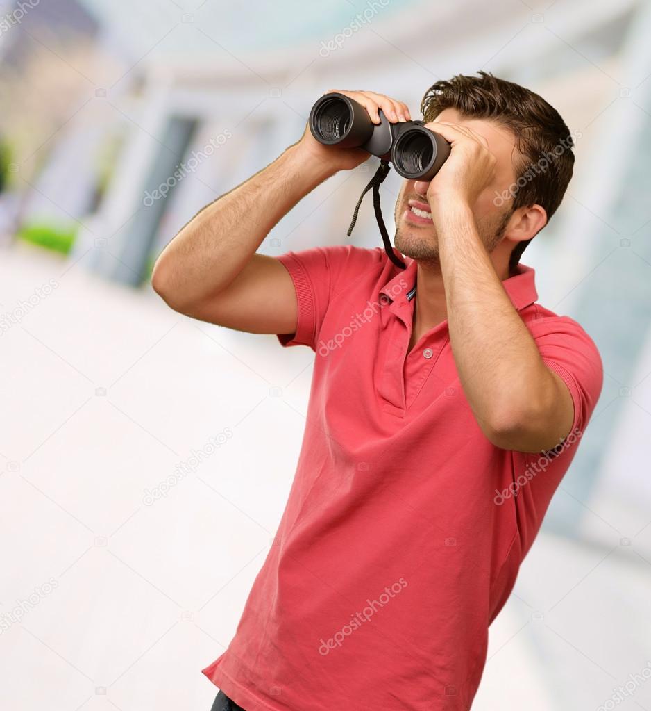 casual man looking into binocular