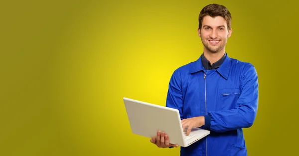 Jovem Técnico feliz trabalhando no laptop — Fotografia de Stock