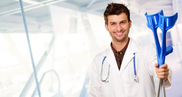 Young Doctor Holding Crouches — Stock Photo, Image