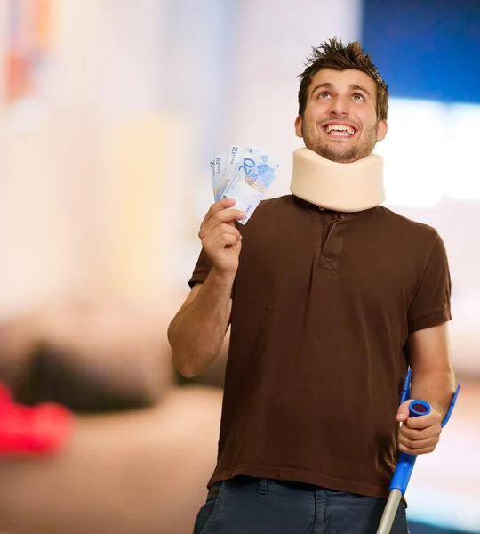 Disabled Man With Neck Brace Holding Euro Note — Stock Photo, Image