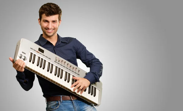 Young Man Holding Piano — Stock Photo, Image