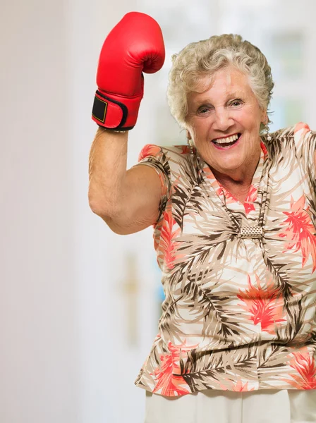 Mujer madura feliz usando guante de boxeo —  Fotos de Stock