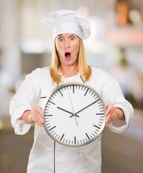 Shocked Female Chef Holding Clock — Stock Photo, Image