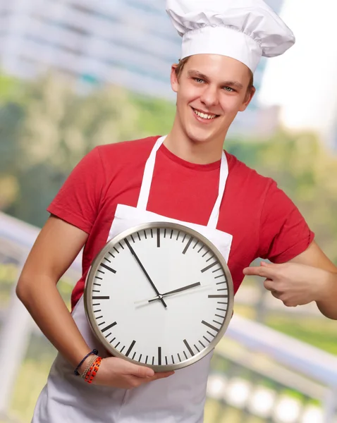 Portrait Of A Young Man Holding A Clock — Stock Photo, Image