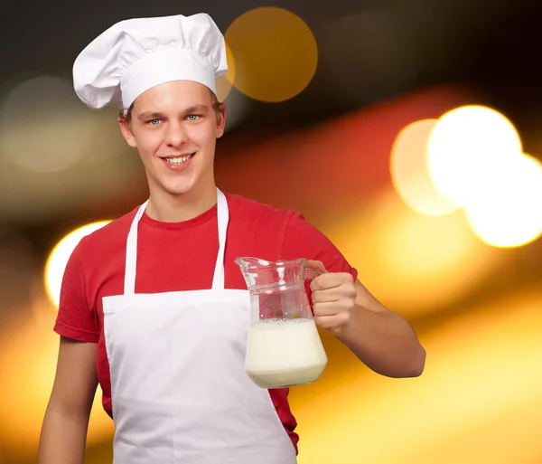 Male chef holding jar of milk — Stock Photo, Image