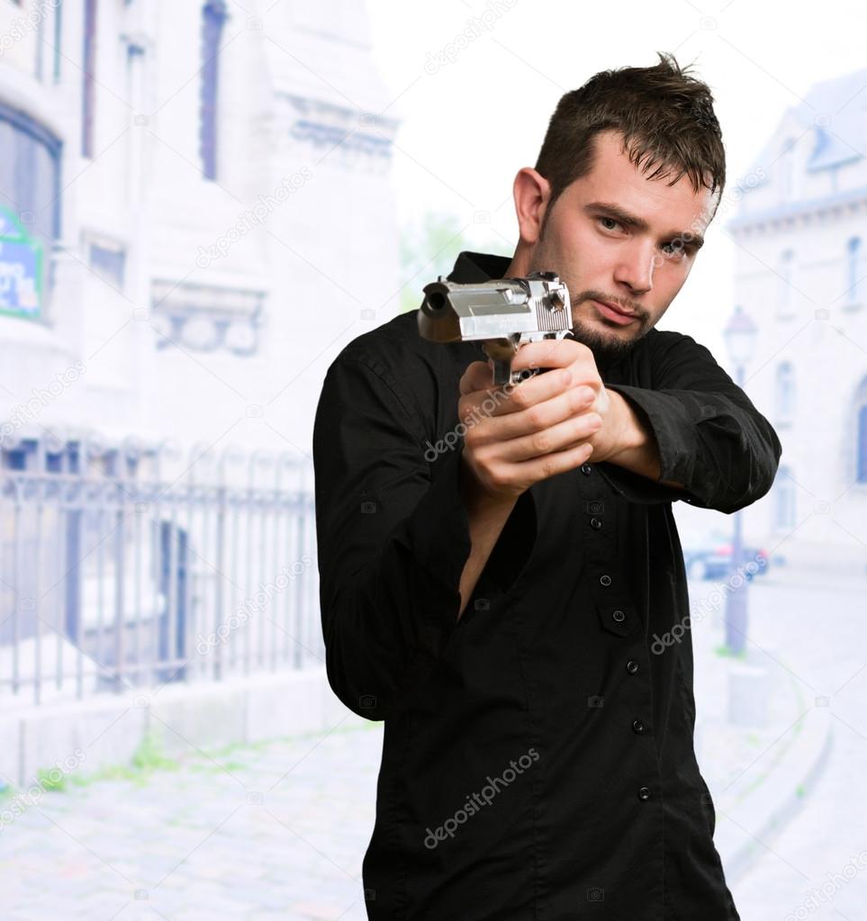 Portrait Of A Man Holding Gun