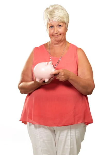 Mujer poniendo moneda en alcancía — Foto de Stock