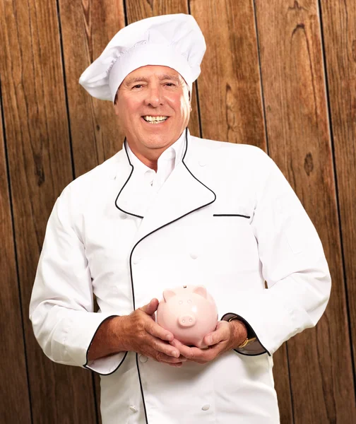 Portrait Of A Chef Holding Piggy Bank — Stock Photo, Image