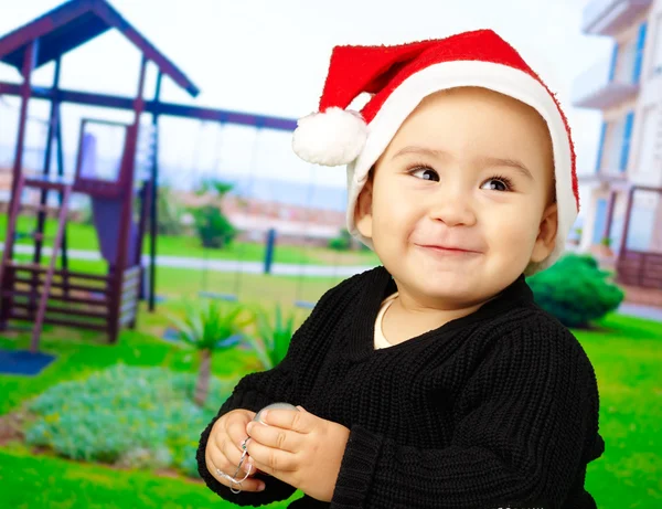 Menino sorrindo e usando um chapéu de Natal — Fotografia de Stock