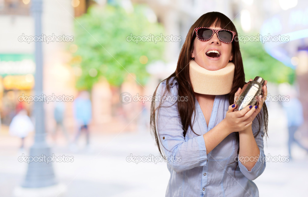 Woman Wearing Neckbrace Holding A Shaker