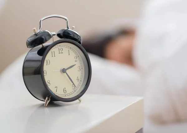 Alarm Clock Beside Bed Royalty Free Stock Images