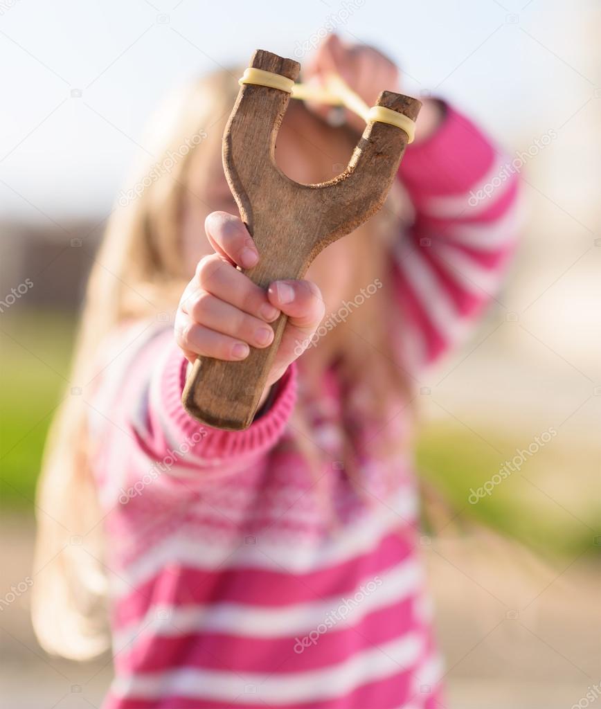 Girl Aiming With A Slingshot