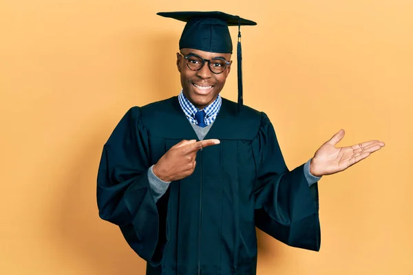 Young African American Man Wearing Graduation Cap Ceremony Robe Amazed — Stock Photo, Image