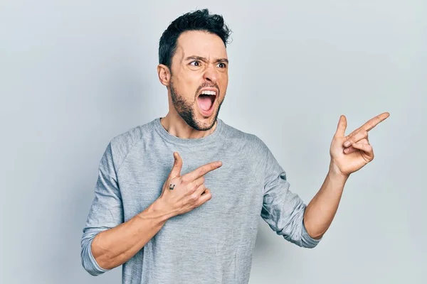 Young Hispanic Man Pointing Fingers Side Angry Mad Screaming Frustrated — Stock Photo, Image