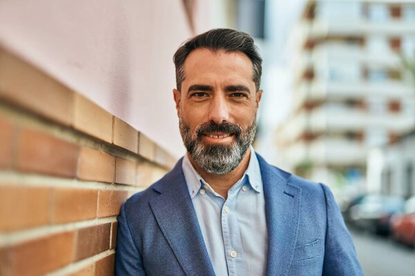 Middle age businessman smiling happy standing at the city.