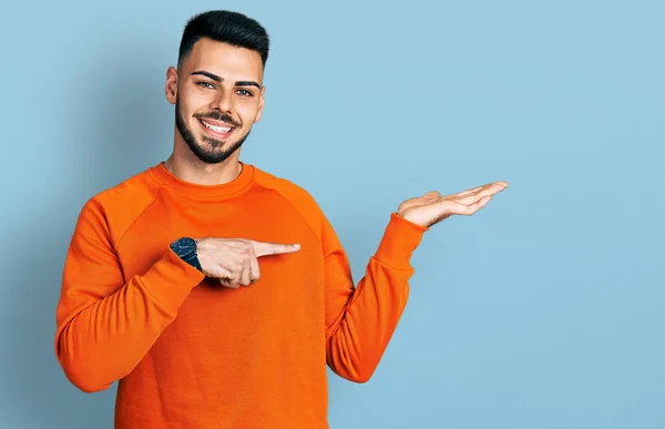 Young Hispanic Man Beard Wearing Casual Orange Sweater Amazed Smiling — Stock Photo, Image