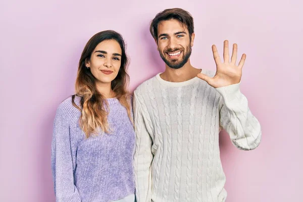 Young Hispanic Couple Wearing Casual Clothes Showing Pointing Fingers Number — Stock Photo, Image