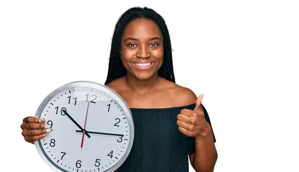 Jovem Afro Americana Segurando Grande Relógio Sorrindo Feliz Positivo Polegar — Fotografia de Stock