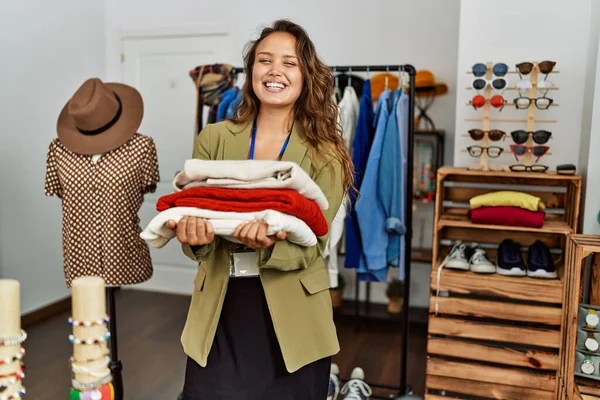 Young Hispanic Shopkeeper Woman Smiling Happy Holding Stack Sweater Clothing — Stock Photo, Image