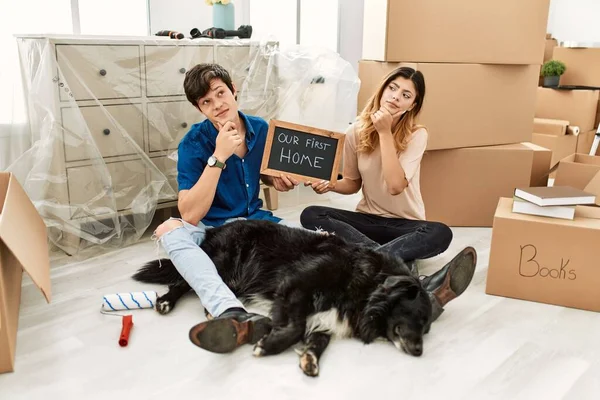 Young Caucasian Couple Dog Holding Our First Home Blackboard New — стоковое фото