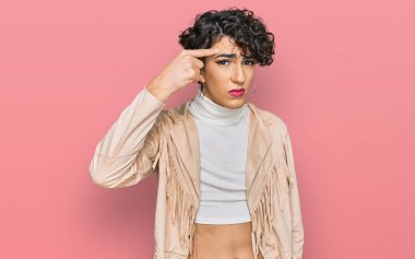 Handsome man wearing make up and woman clothes pointing unhappy to pimple on forehead, ugly infection of blackhead. acne and skin problem 