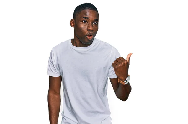 Young African American Man Wearing Casual White Shirt Surprised Pointing — Stock Photo, Image