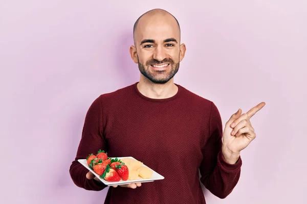 Young Bald Man Eating Fresh Healthy Fruits Smiling Happy Pointing — Stock Photo, Image