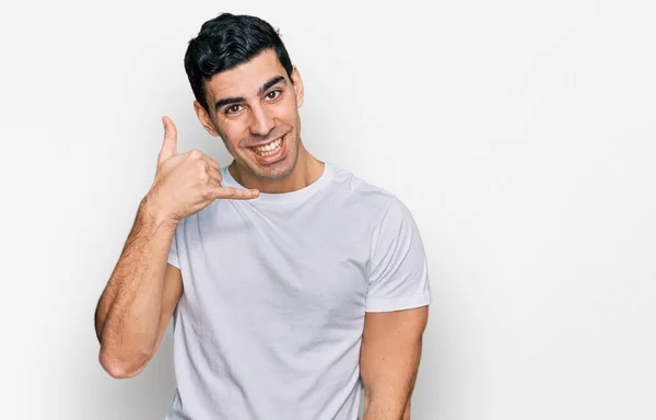 Pohledný Hispánec Obyčejné Bílé Košili Usmívající Mávající Rukama Prsty Jako — Stock fotografie
