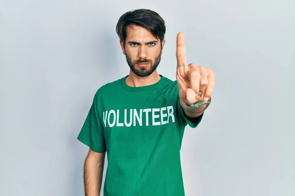 Jovem Hispânico Vestindo Shirt Voluntária Apontando Com Dedo Para Cima — Fotografia de Stock