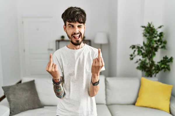 Hispanic Man Beard Living Room Home Showing Middle Finger Doing — Φωτογραφία Αρχείου