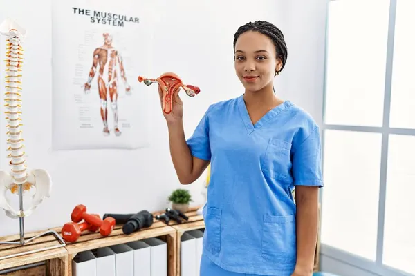 Young African American Woman Wearing Physio Therapist Uniform Holding Anatomical — Stock Photo, Image