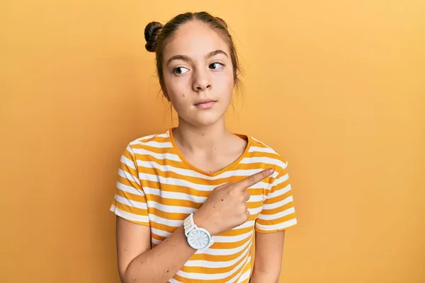 Beautiful Brunette Little Girl Wearing Casual Striped Shirt Pointing Hand — Stock Photo, Image