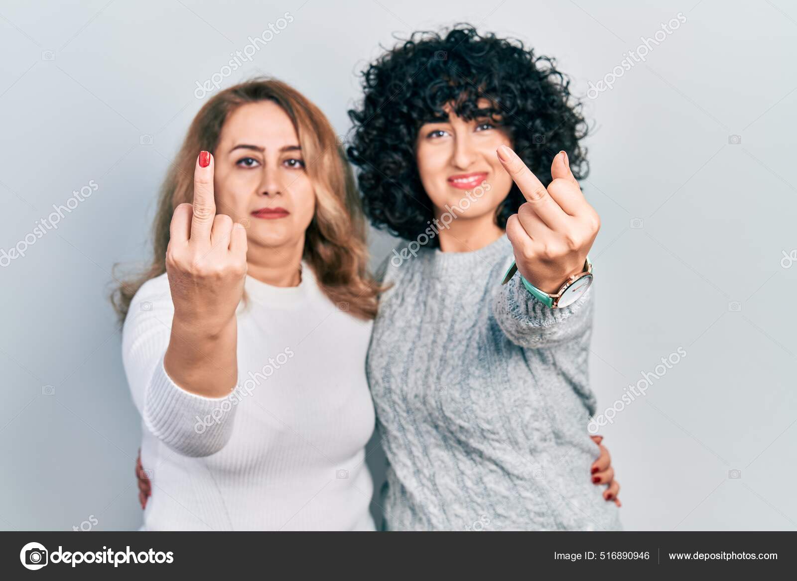 Middle East Mother Daughter Wearing Casual Clothes Showing Middle Finger Stock Photo by ©Krakenimages 516890946 image