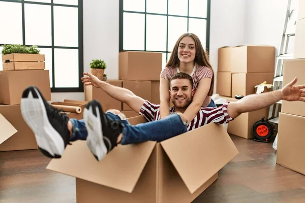 Young Caucasian Couple Smiling Happy Playing Using Cardboard Box Car — Stock Photo, Image