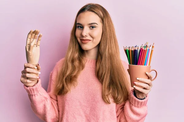 Young Blonde Woman Holding Small Wooden Manikin Hand Pencils Smiling — Stock Photo, Image