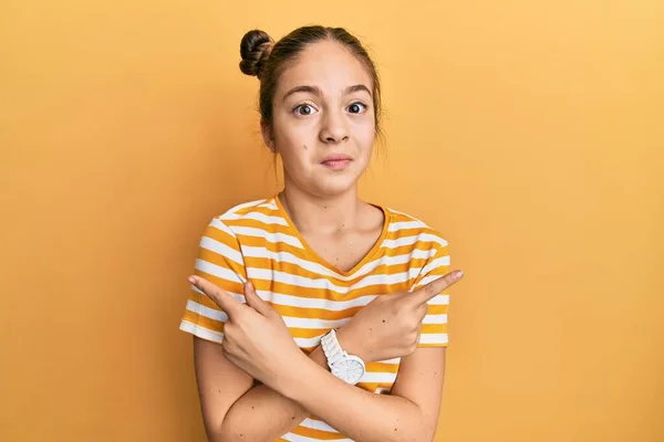 Beautiful Brunette Little Girl Wearing Casual Striped Shirt Pointing Both — Stock Photo, Image