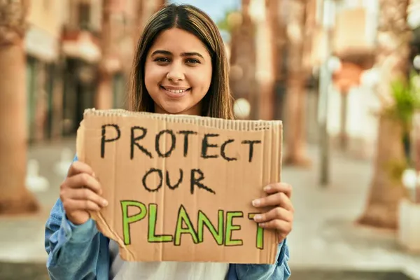 Jovem Latina Sorrindo Feliz Segurando Proteger Nosso Banner Planeta Cidade — Fotografia de Stock