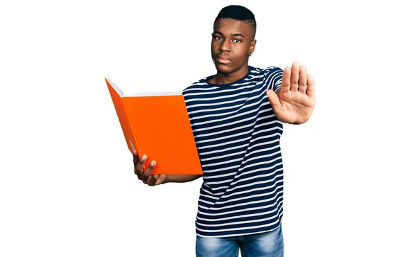 Young African American Man Holding Book Open Hand Doing Stop — Stock Photo, Image