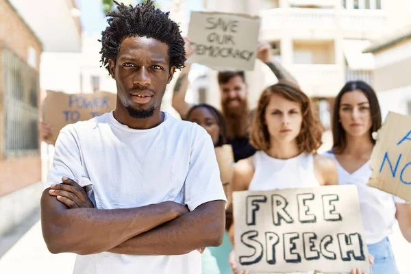 Young Activist Man Arms Crossed Gesture Standing Group Protesters Holding — Stock Photo, Image